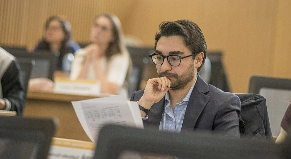 Student looking at papers in class.