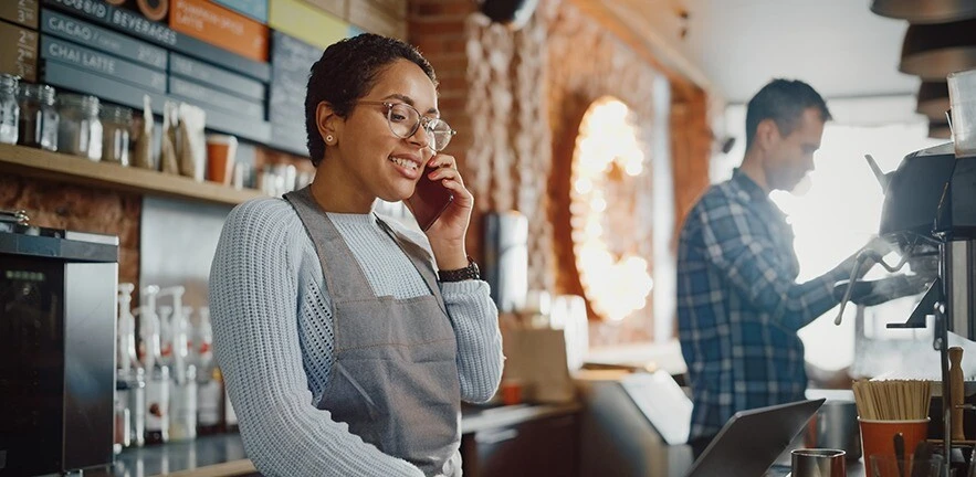 Couple working in their family cafe.