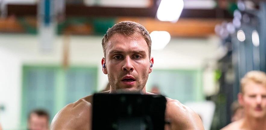 Rowers looking focussed while training in the gym.