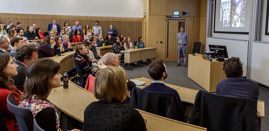 Lecture theatre full of people.