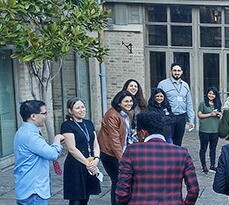 Al-Mada programme participants having a break in one of the College gardens.