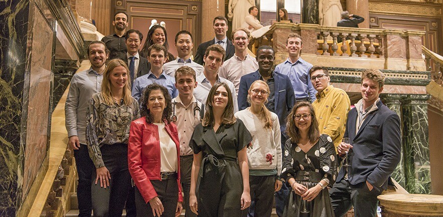 A group of EnterpriseTECH STAR alumni on a grand staircase.