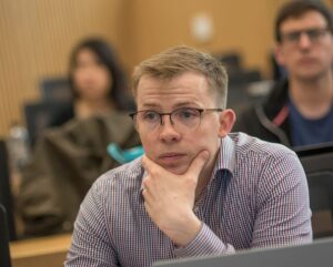 MBA student listening in class.