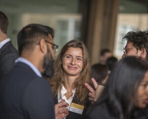 MBA student smiling at peers.