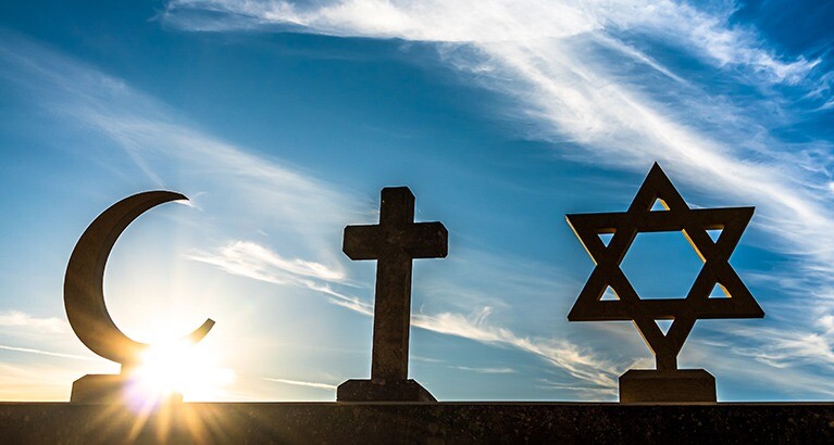 Religious symbols in front of blue skies.