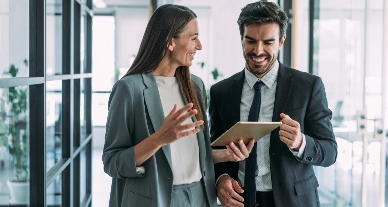 People in a work environment smiling.