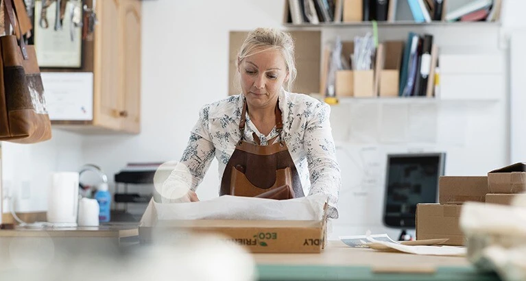 Woman packing with eco packaging.