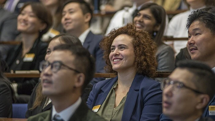 MBA student smiling in class.