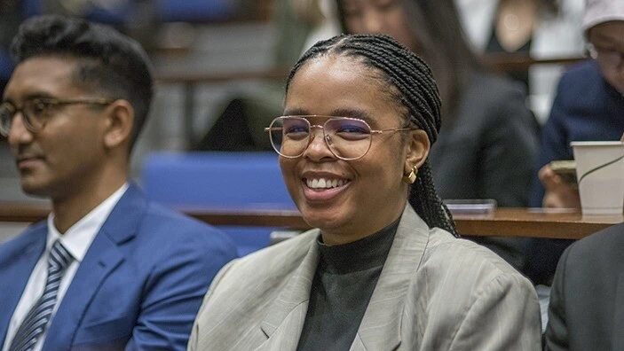 MBA student smiling in class.