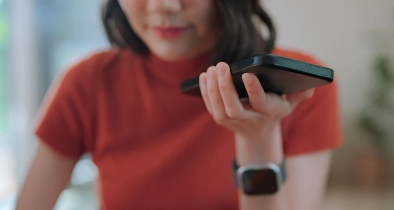 Woman with red top talking on the phone.