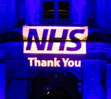 Cambridge Judge Business School lit in blue for NHS by Absolute Audio Visual Solutions. Photo credit David Amann.