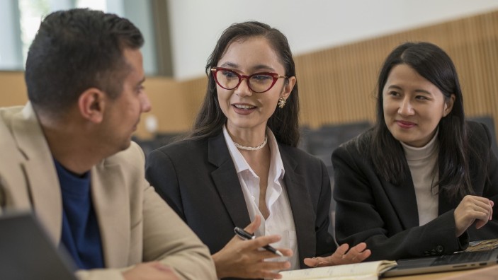 3 students smiling.