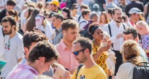 London, UK - 17 June, 2022 - Crowd of train passengers waiting frustratingly outside the Euston Station due to temporary service closure on one of the hottest days of the year.